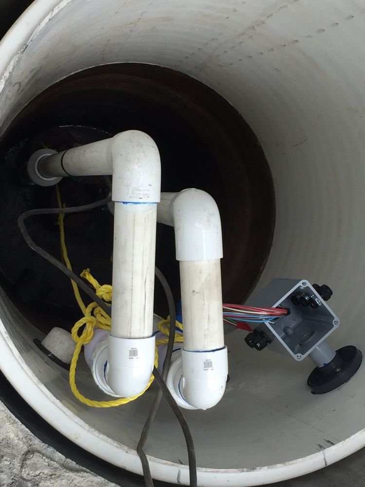 PVC discharge piping and junction box inside a septic pump riser